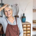 female entrepreneur wearing apron in retail shop