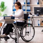 woman in wheelchair at work place