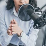 Cropped photo of woman speaking into microphone