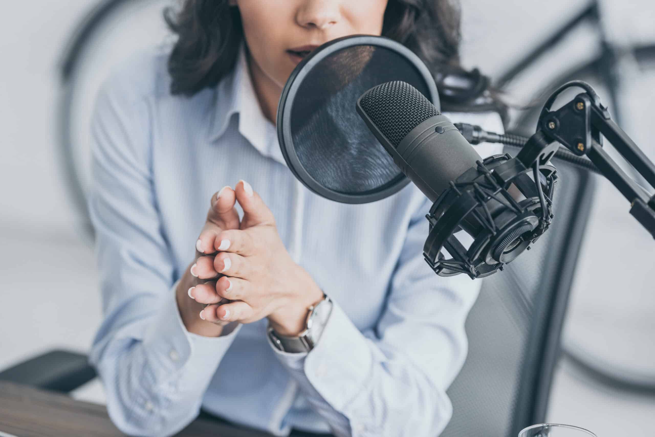 Cropped photo of woman speaking into microphone