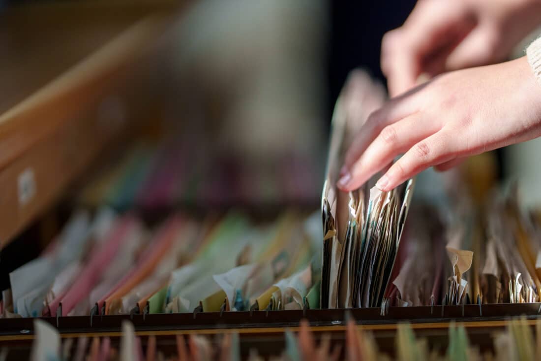 woman sorting through file drawer